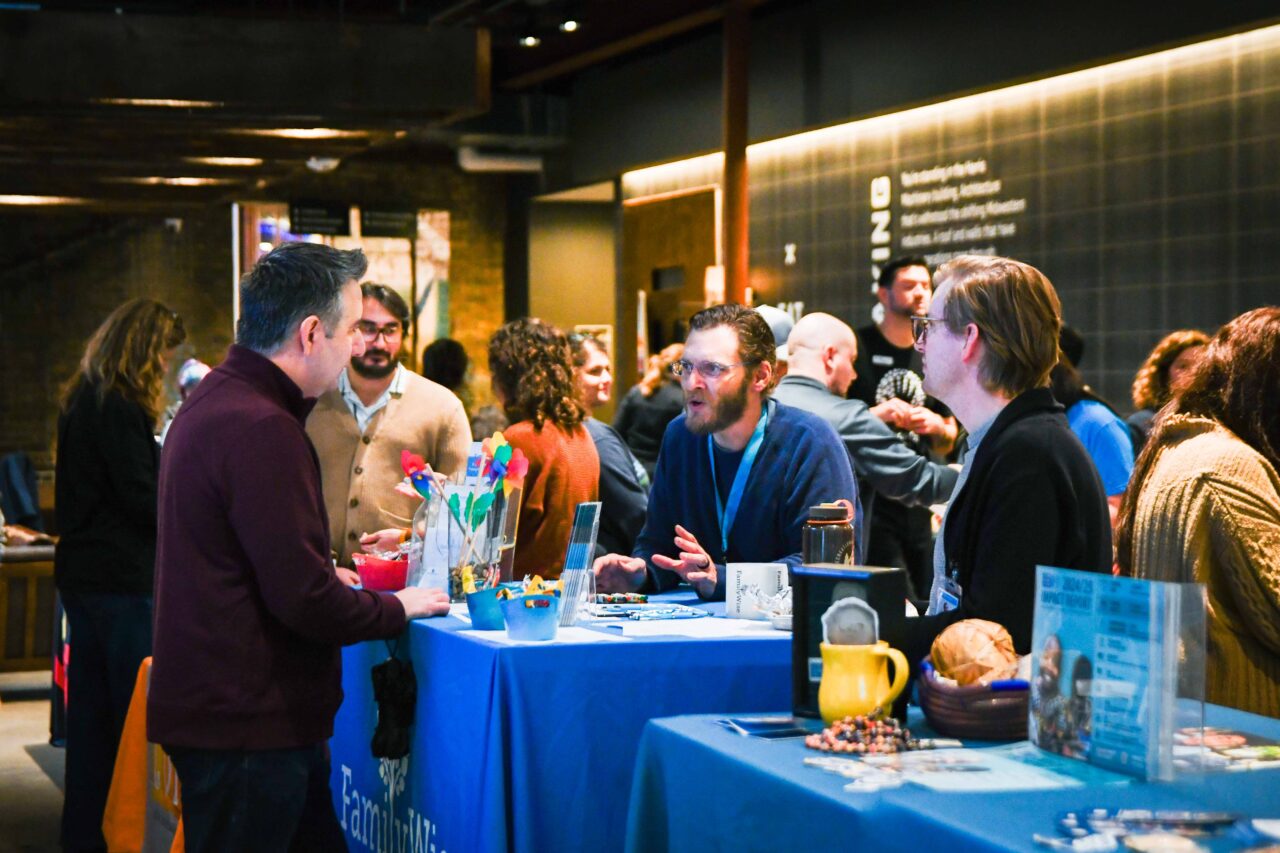 Two FamilyWise staff talk to a potential volunteer